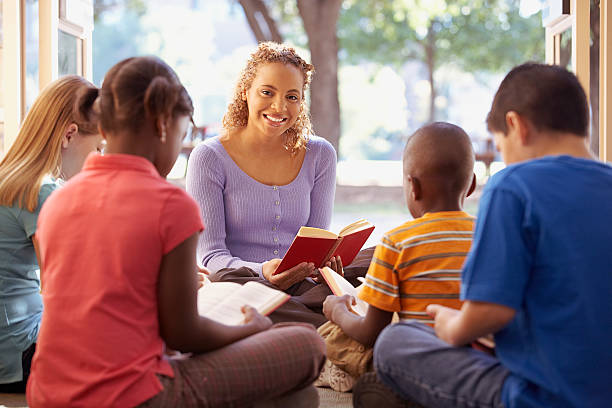 Adult and children sitting down with a book