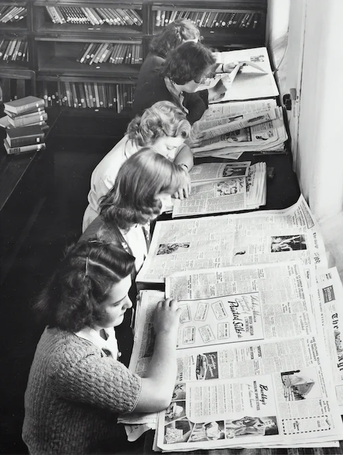 Ladies looking at newspapers