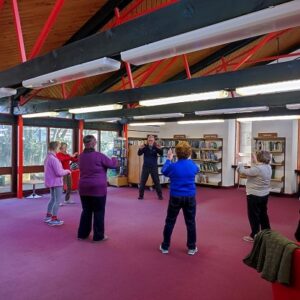 People doing Tai Chi in a library